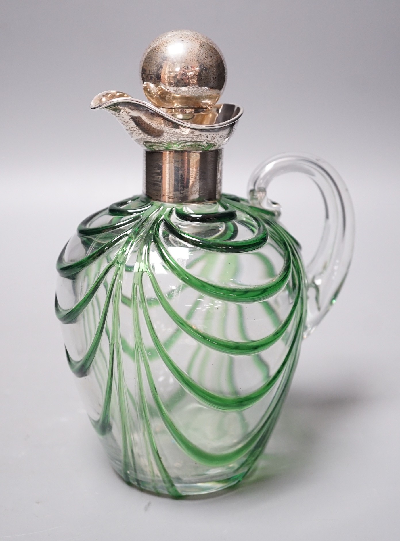 A late Victorian Art Nouveau silver mounted glass claret jug and stopper, D & M Davis, Birmingham, 1900, the glass with ribbed green swags, height 20.7cm.